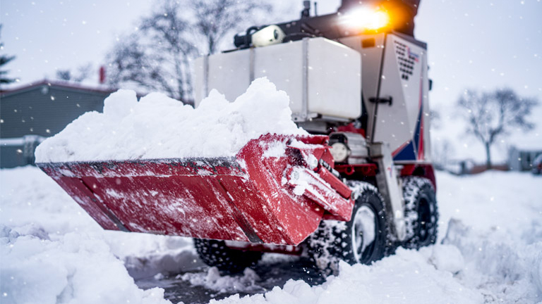 Professional snow removal clearing a commercial property in Cambridge, MN Professional snow removal clearing a commercial property in Cambridge, MN
