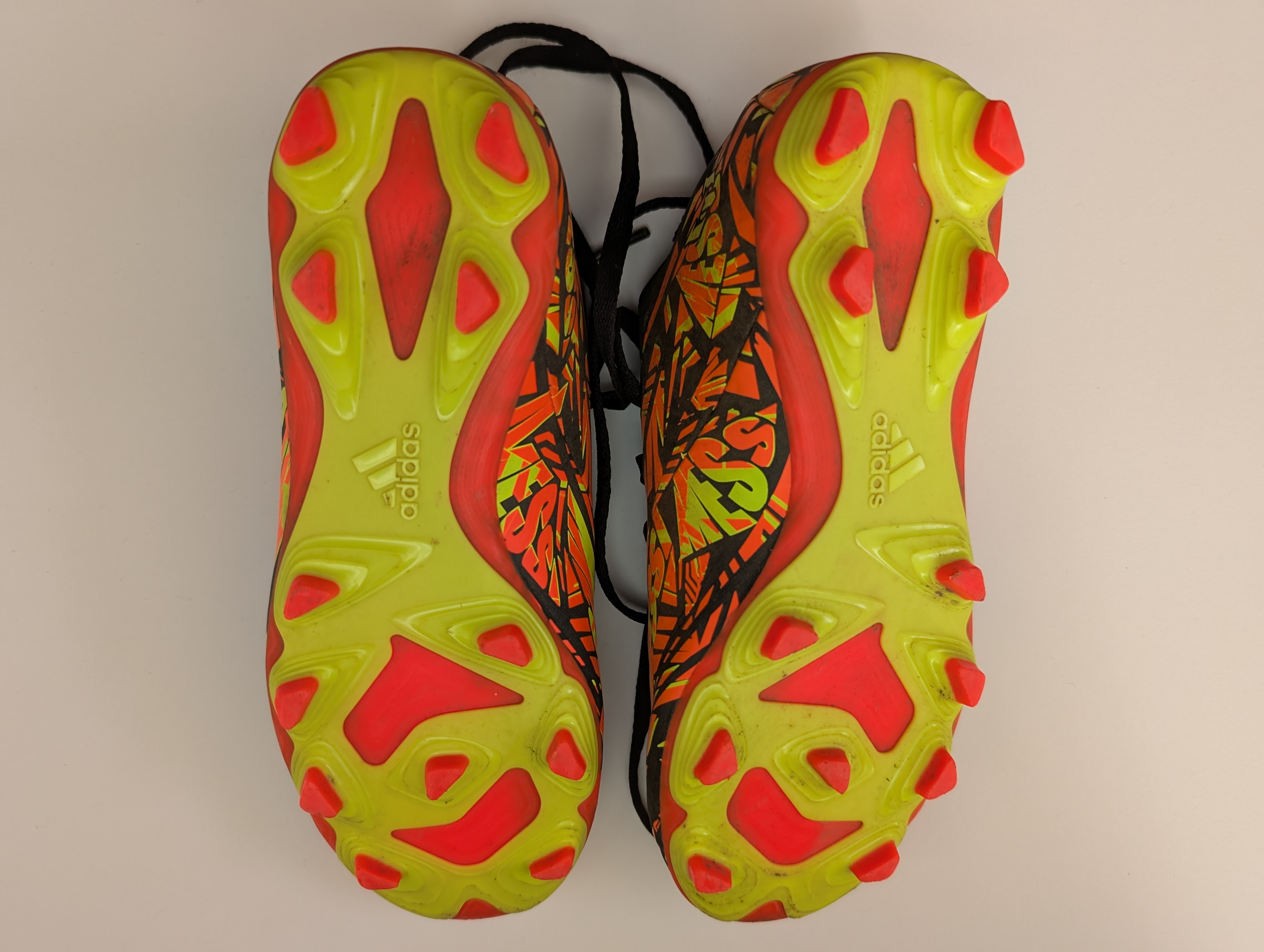 Bottom of a pair of yellow and orange football boots showing what blades look like Bottom of a pair of yellow and orange football boots showing what blades look like