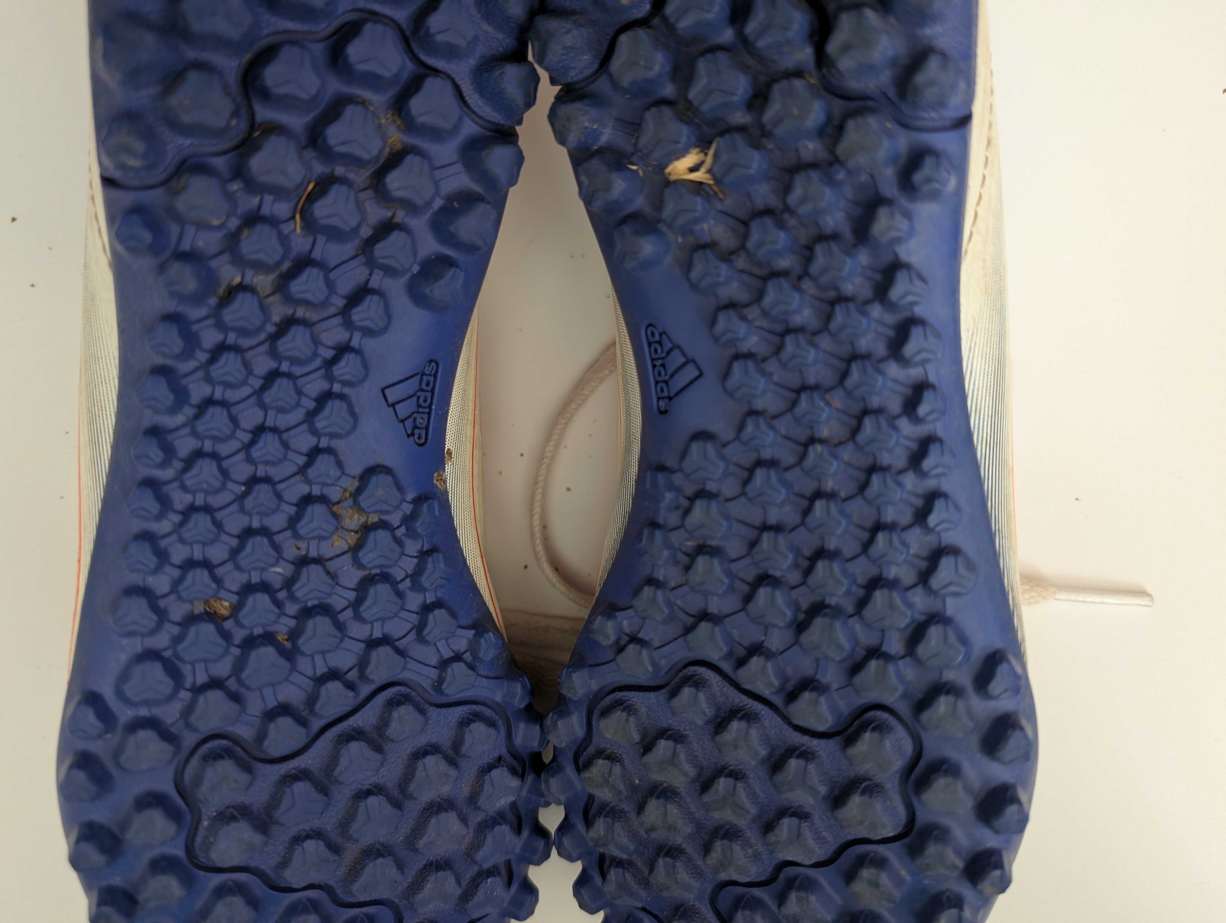 The bottom of a pair of astro/turf trainer football boots showing all the dimple-like studs The bottom of a pair of astro/turf trainer football boots showing all the dimple-like studs