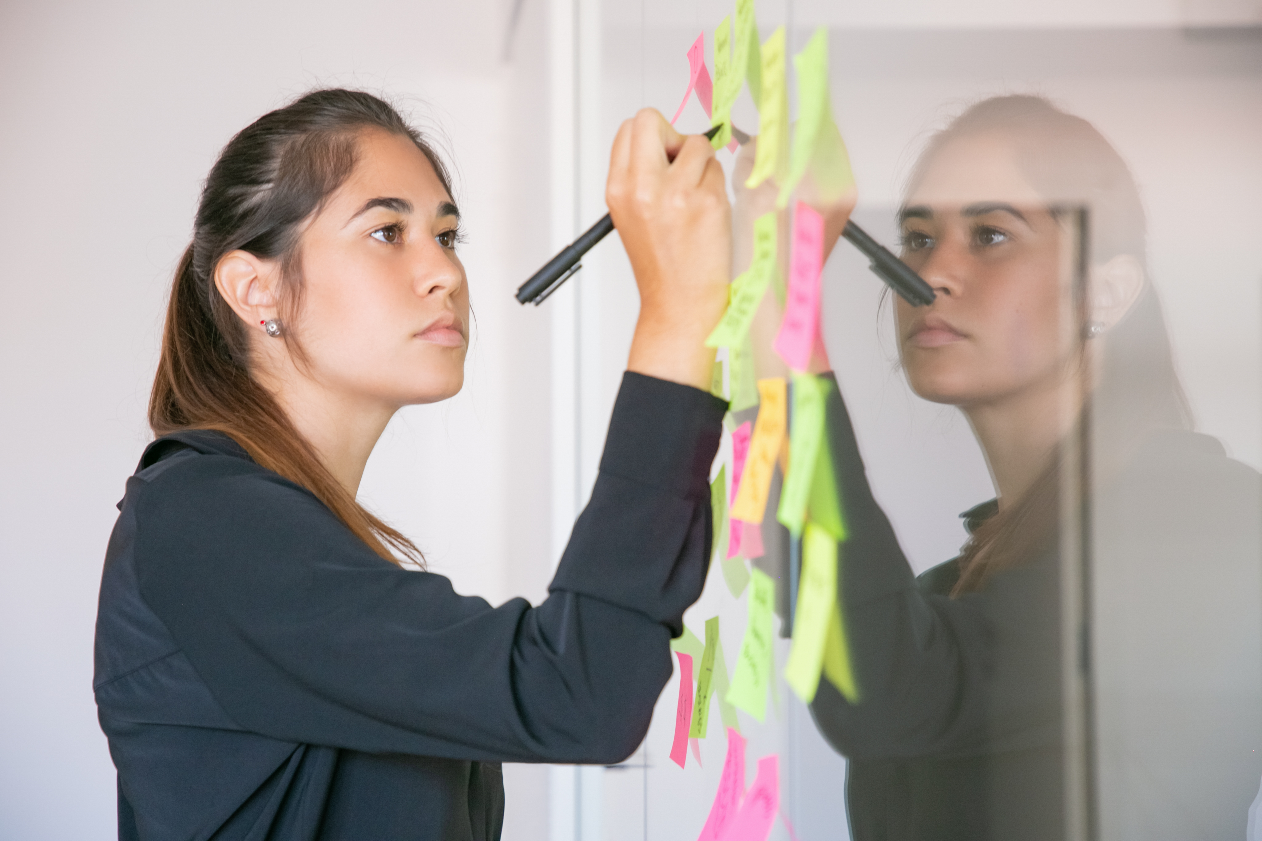 young woman writing sticker with marker