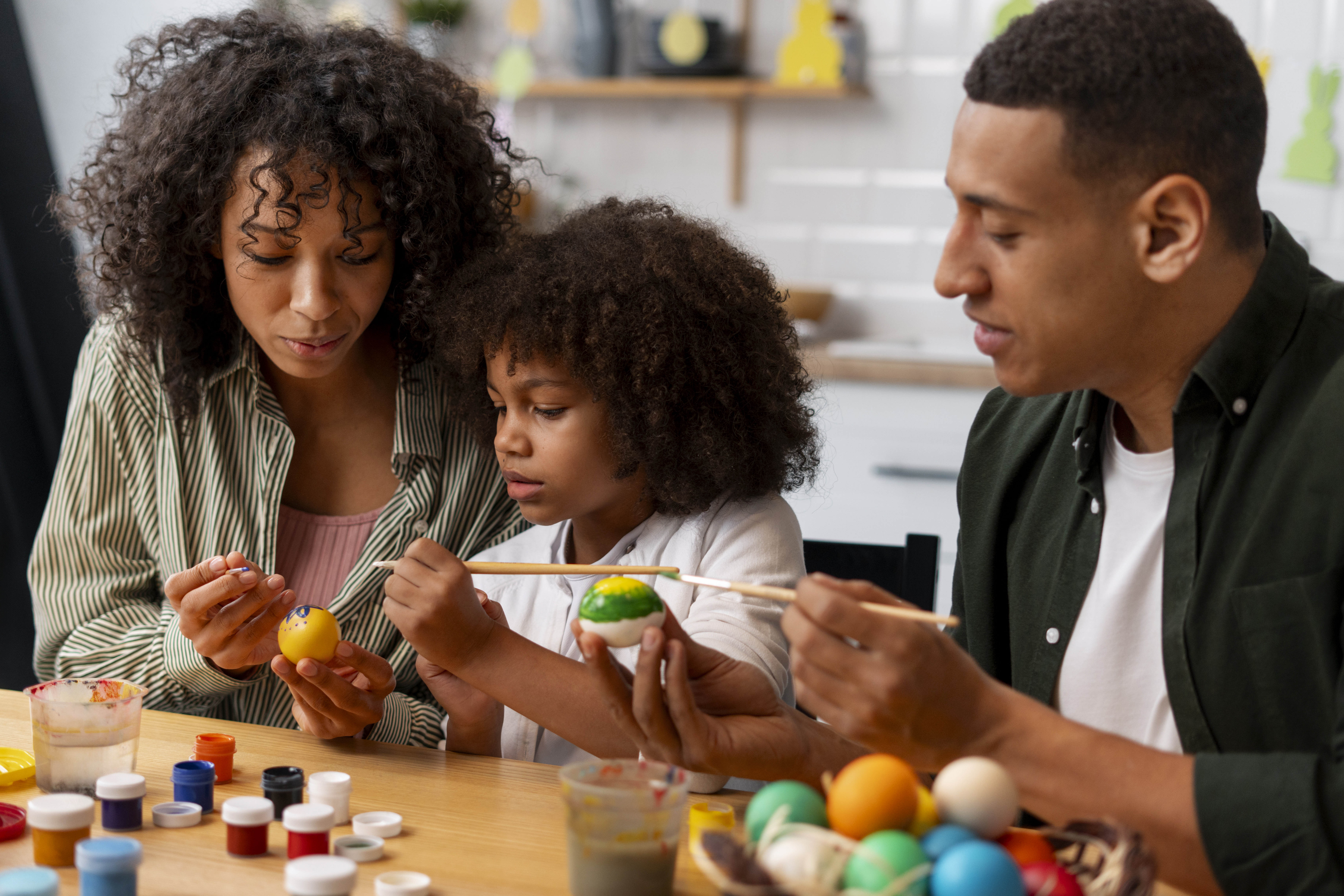 family painting an easter egg
