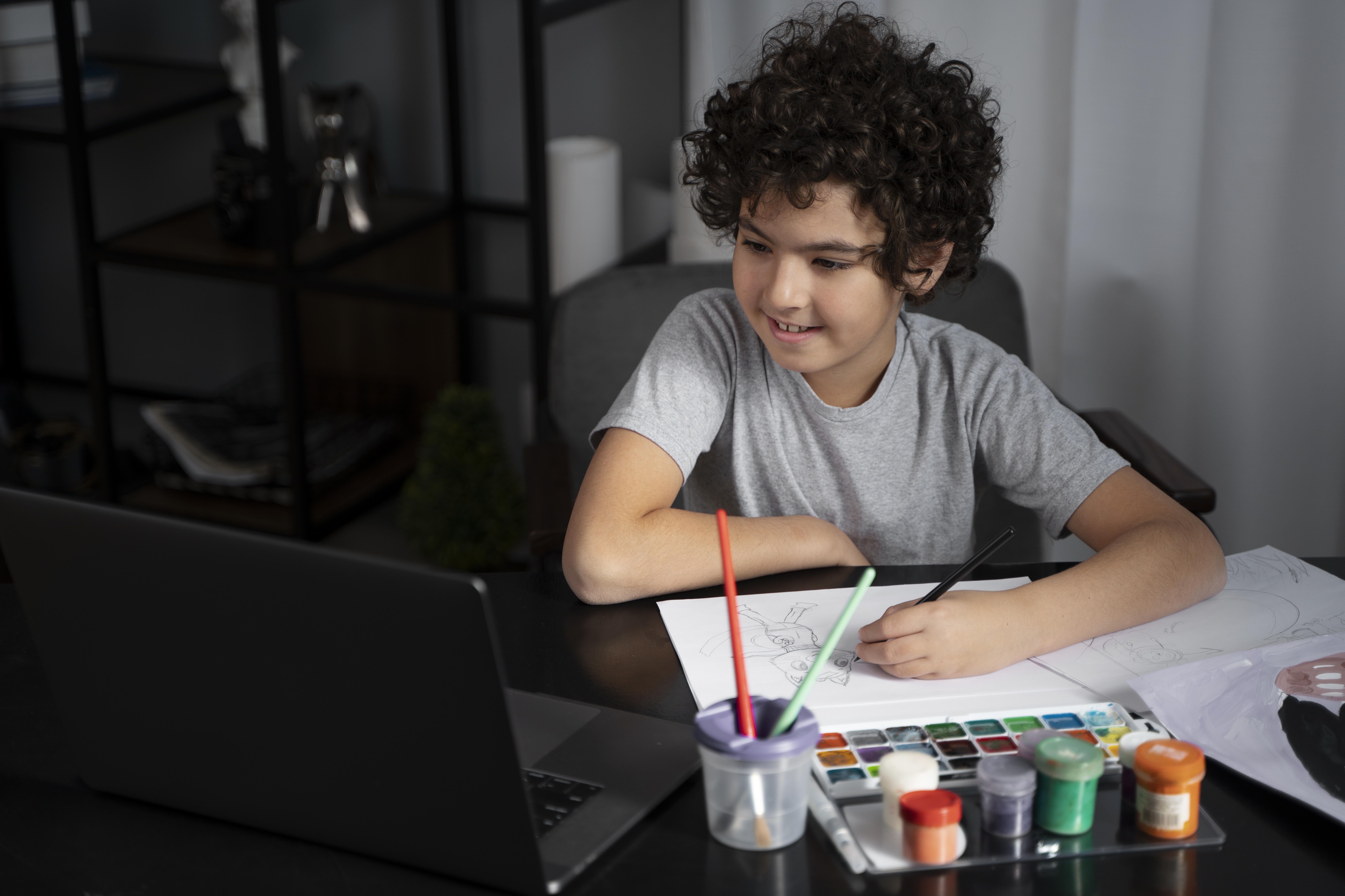 young man painting with watercolor