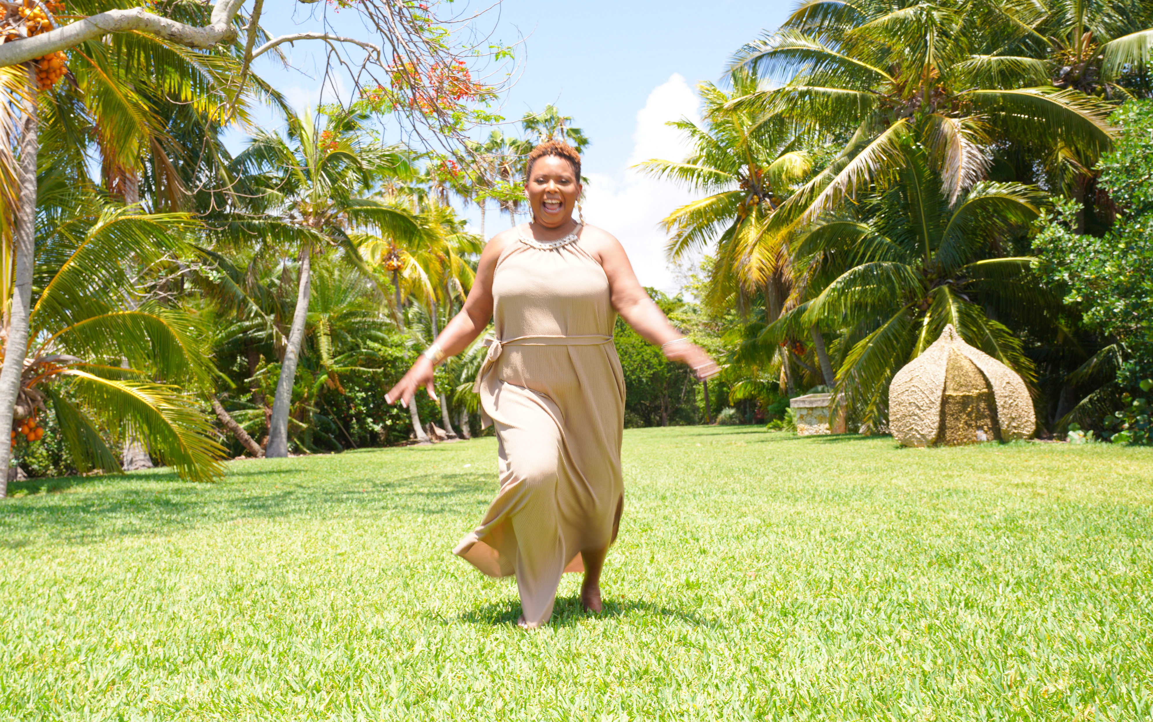 Woman running outside in a brown dress Woman running outside in a brown dress
