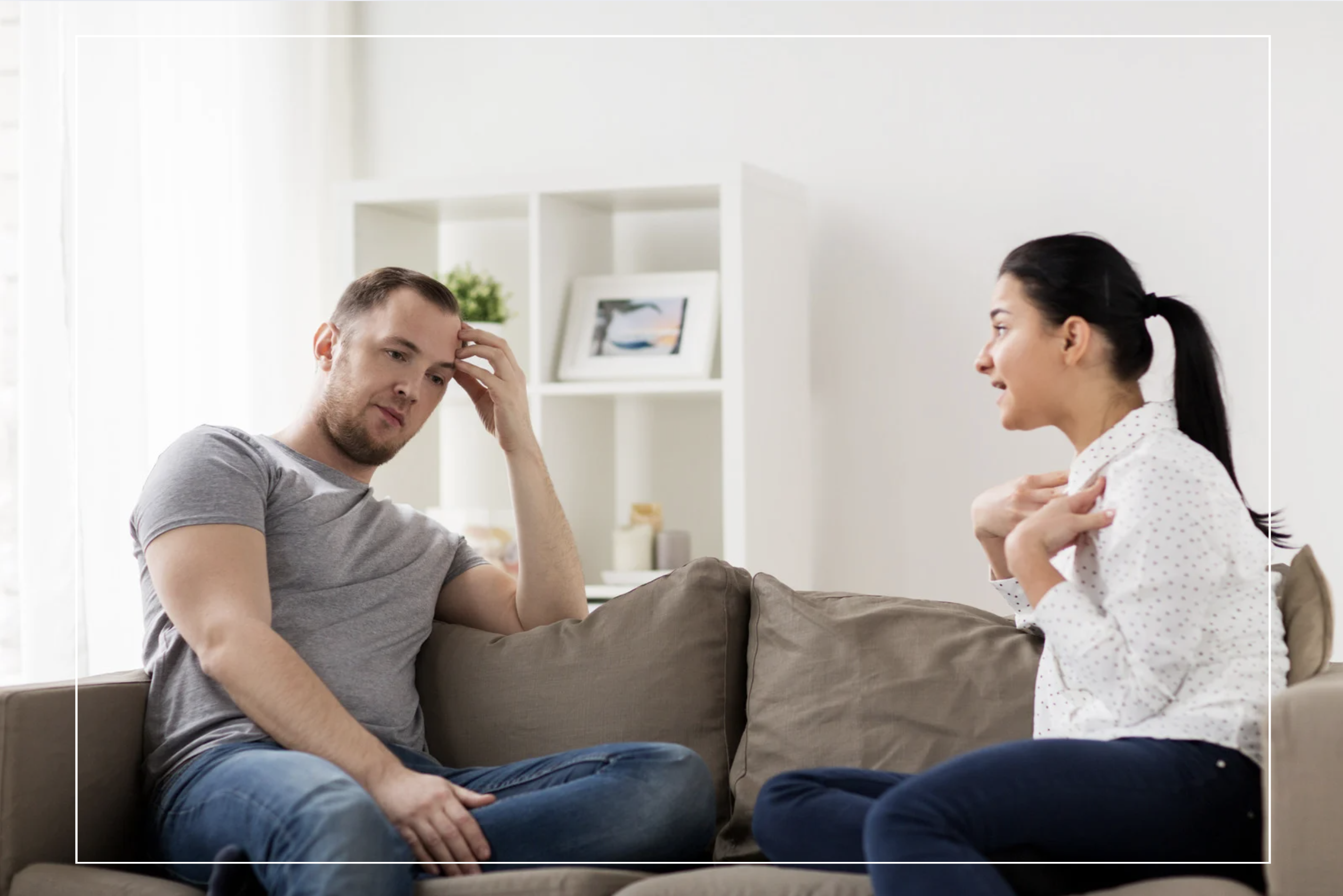 A woman expressing herself during a serious conversation while her male partner looks emotionally withdrawn and disengaged, illustrating communication breakdown in relationships. A woman expressing herself during a serious conversation while her male partner looks emotionally withdrawn and disengaged, illustrating communication breakdown in relationships.
