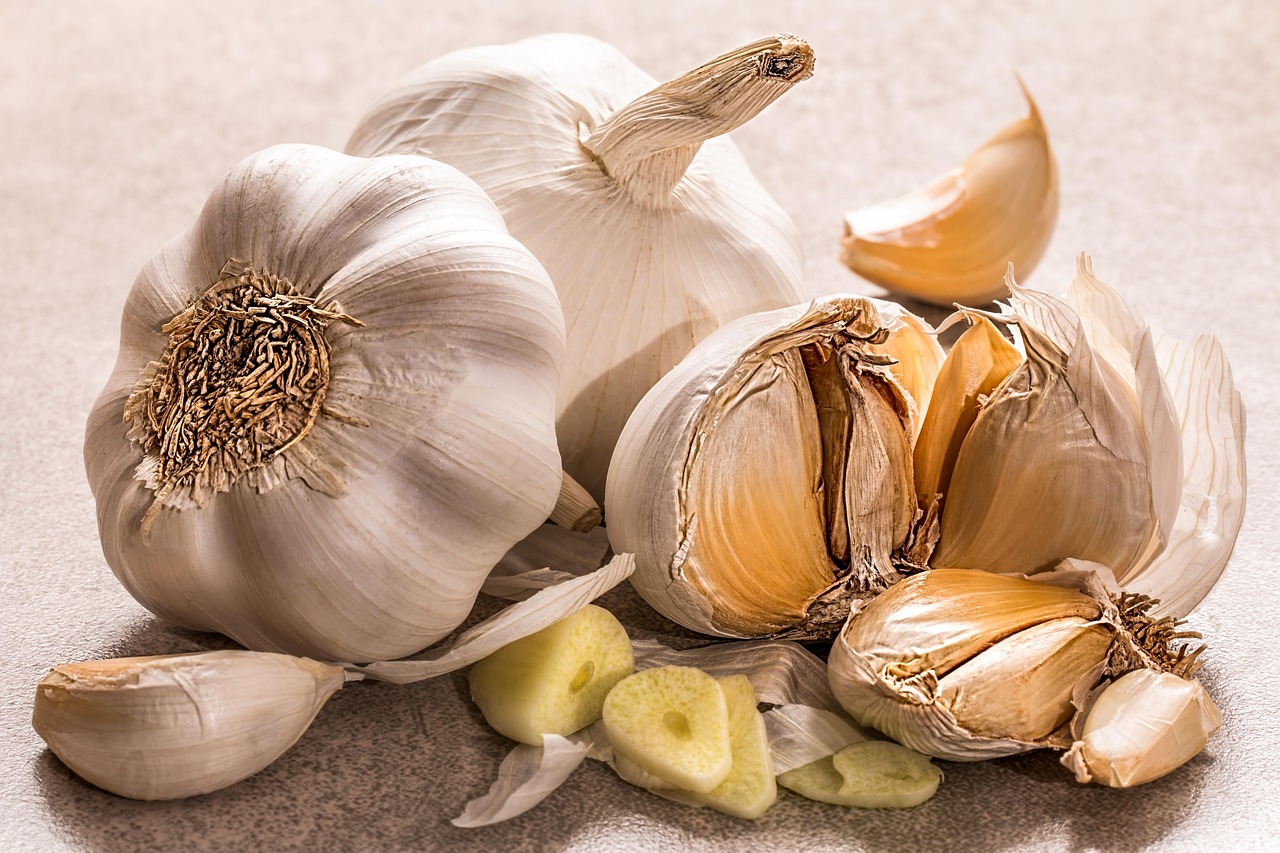 Health supplement capsules and fresh garlic on wooden table Health supplement capsules and fresh garlic on wooden table