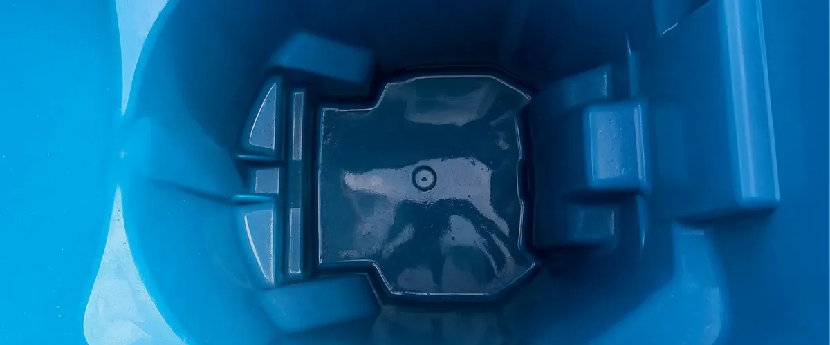 Interior view of a clean blue trash bin bottom