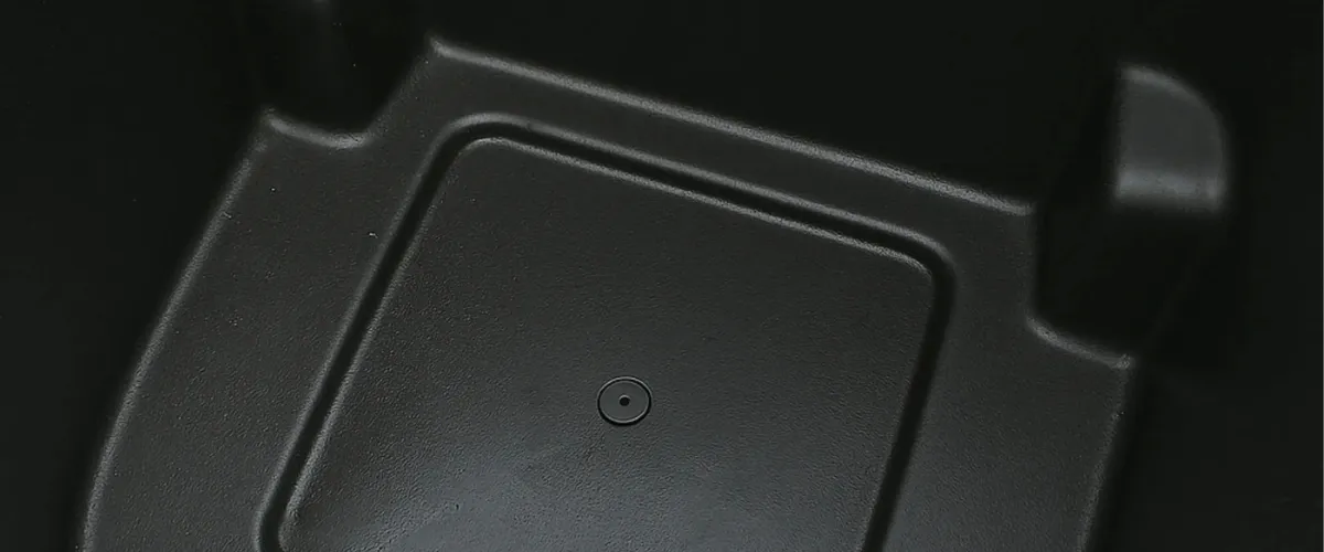 Interior of an empty black trash bin with a clean, textured plastic surface.
