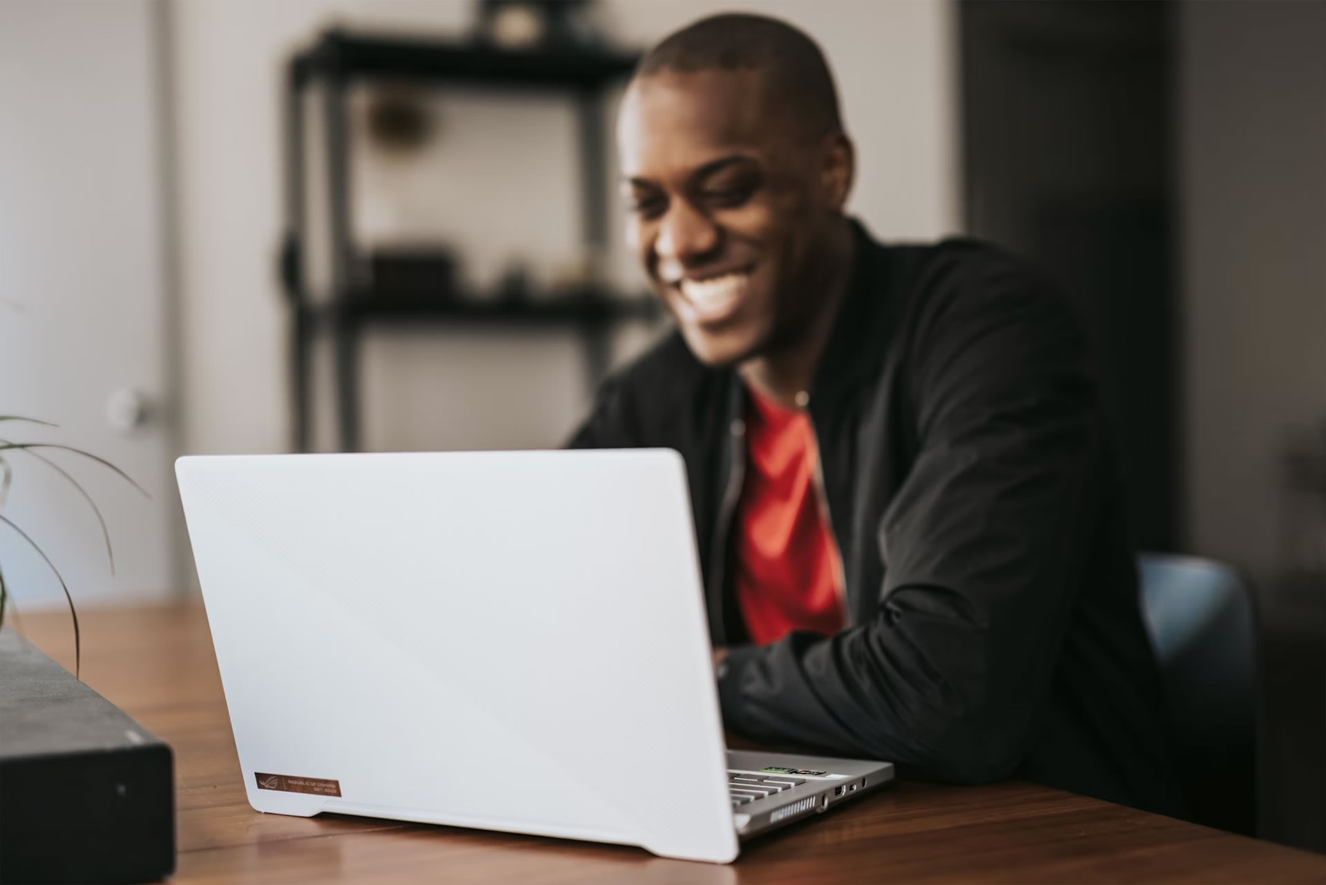 man-in-black-blazer-sitting-by-the-table-with-laptop man-in-black-blazer-sitting-by-the-table-with-laptop
