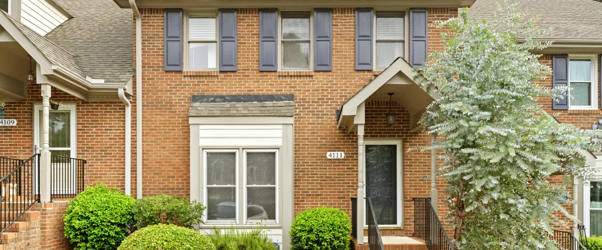“Brick townhome exterior with fresh, clean appearance after power washing