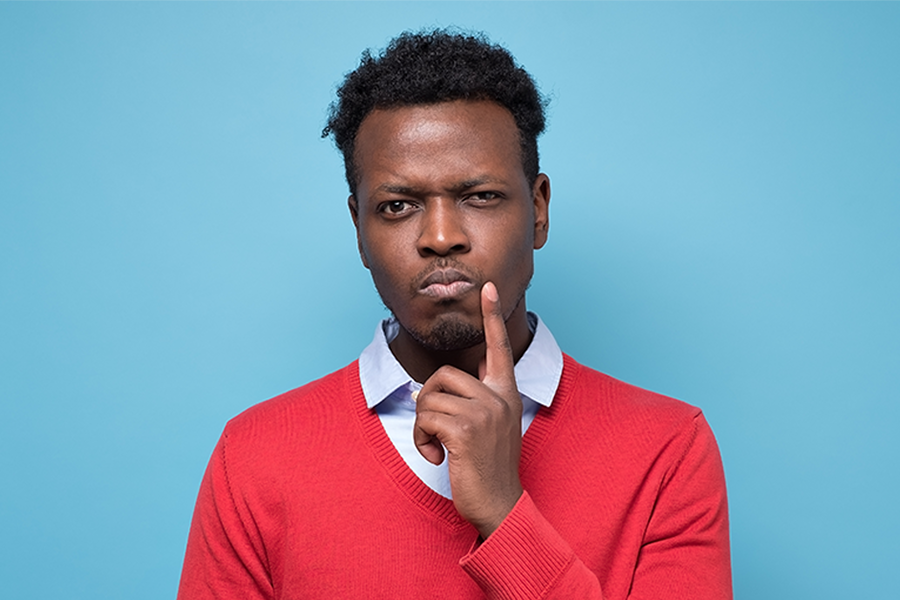Man pondering all the things he needs to do for his new website Man pondering all the things he needs to do for his new website