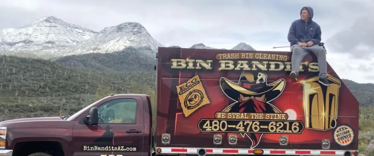 Eco-friendly Bin Bandits trash bin cleaning truck with scenic Carefree, Arizona mountains in background. Eco-friendly Bin Bandits trash bin cleaning truck with scenic Carefree, Arizona mountains in background.