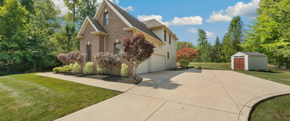 Beautiful residential home with a clean concrete driveway after pressure washing. Beautiful residential home with a clean concrete driveway after pressure washing.