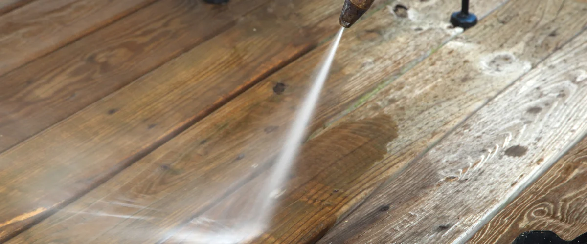 Pressure washing a wooden deck to remove dirt and stains Pressure washing a wooden deck to remove dirt and stains