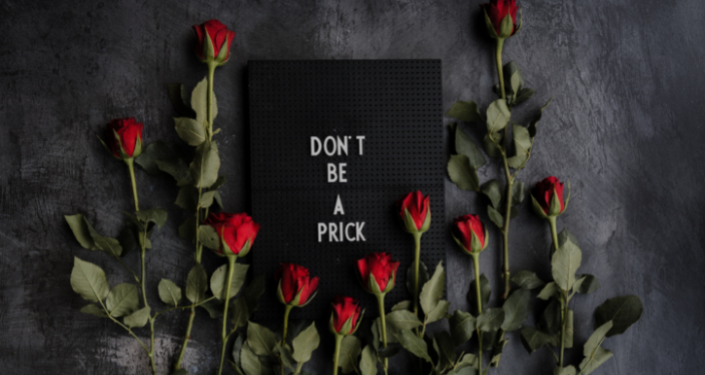 black board with text and red roses