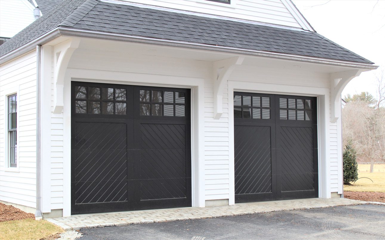 Black double garage doors on white home in Easton CT