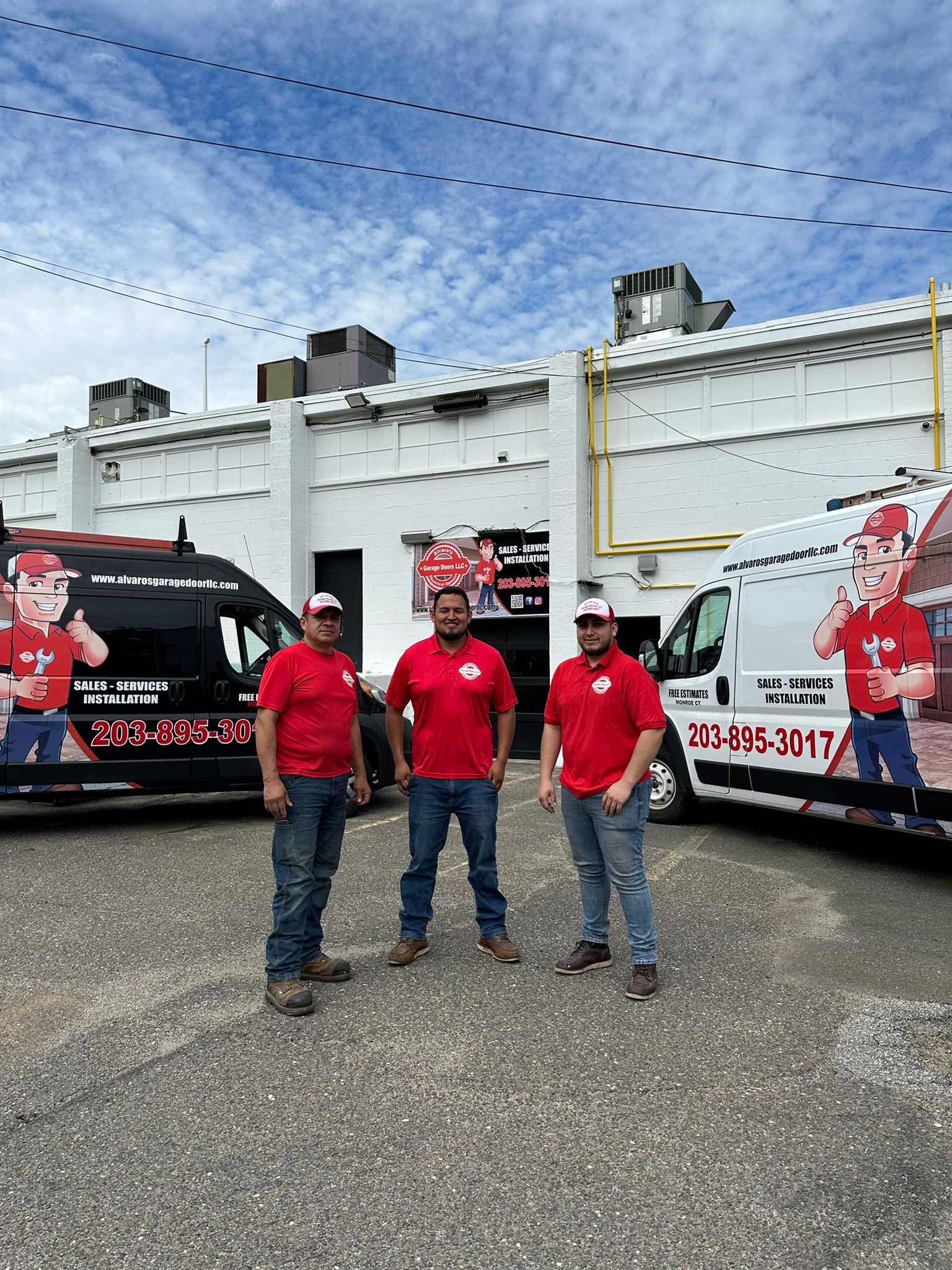 Alvaro’s Garage Doors LLC team in front of vans