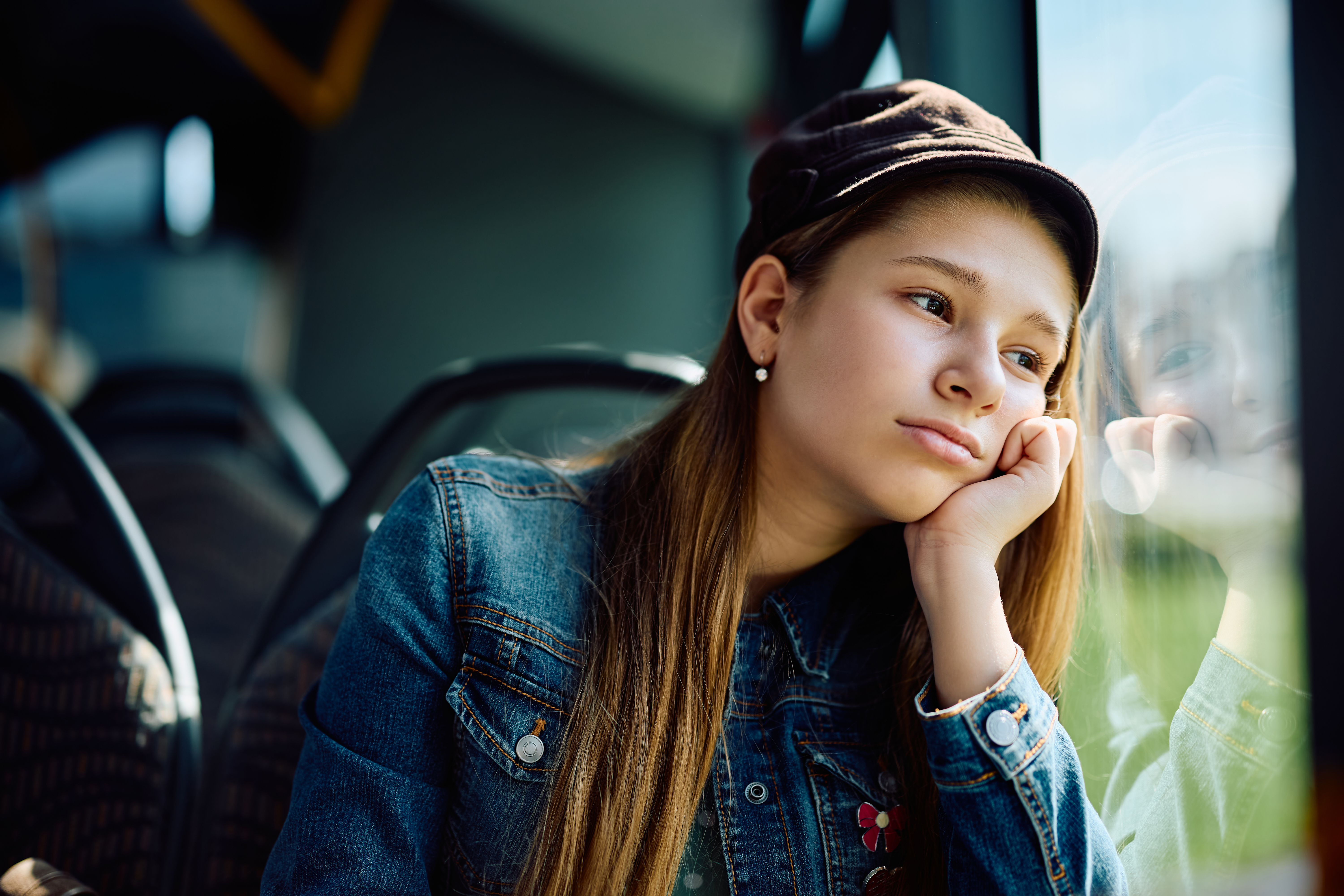 Teenage girl looking sad on bus Teenage girl looking sad on bus