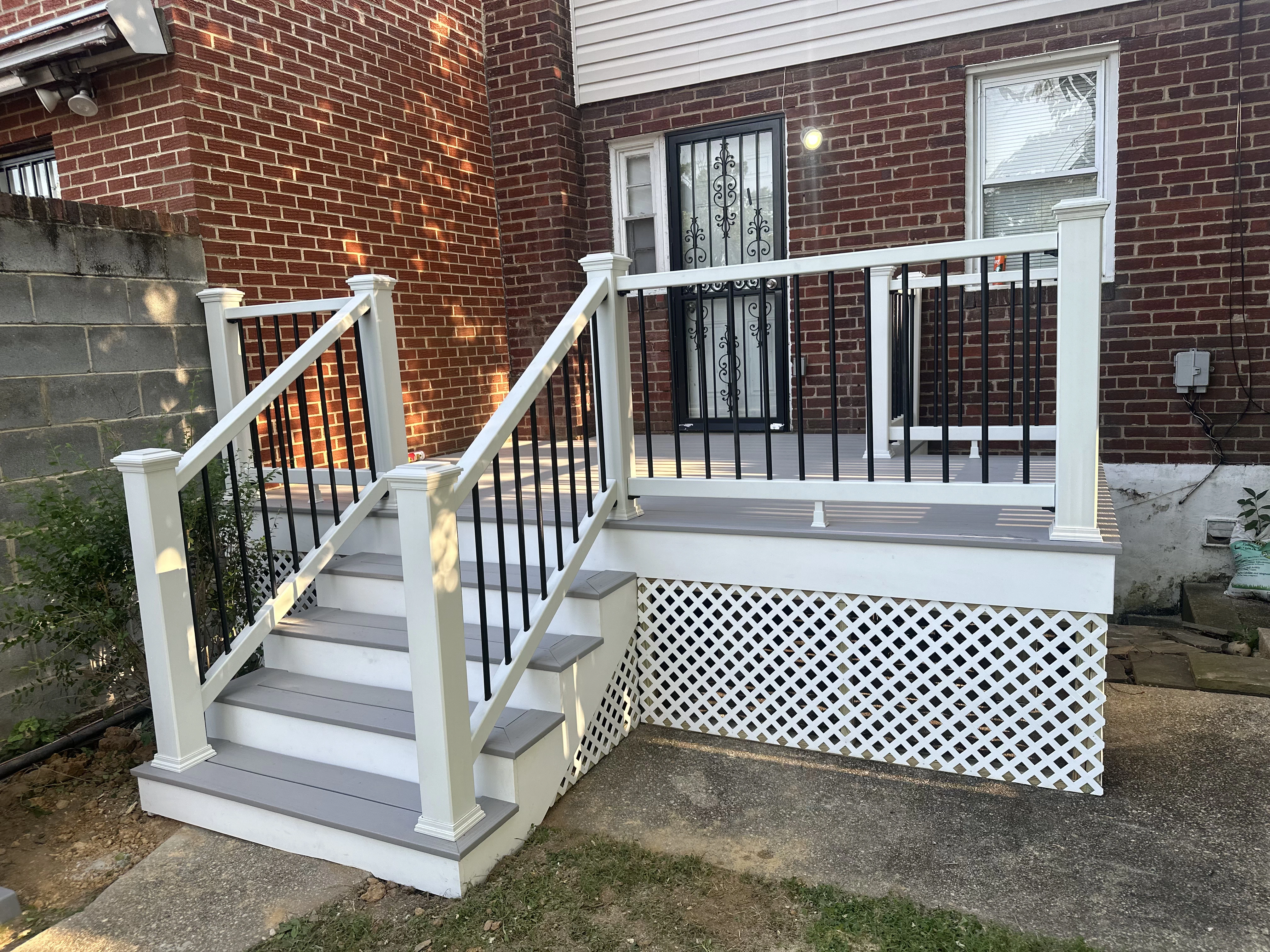 A spacious deck with white railings and steps, enhancing outdoor living space.