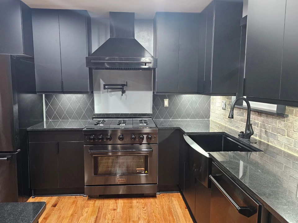 Contemporary kitchen design with black cabinetry and stainless steel appliances for a stylish look.