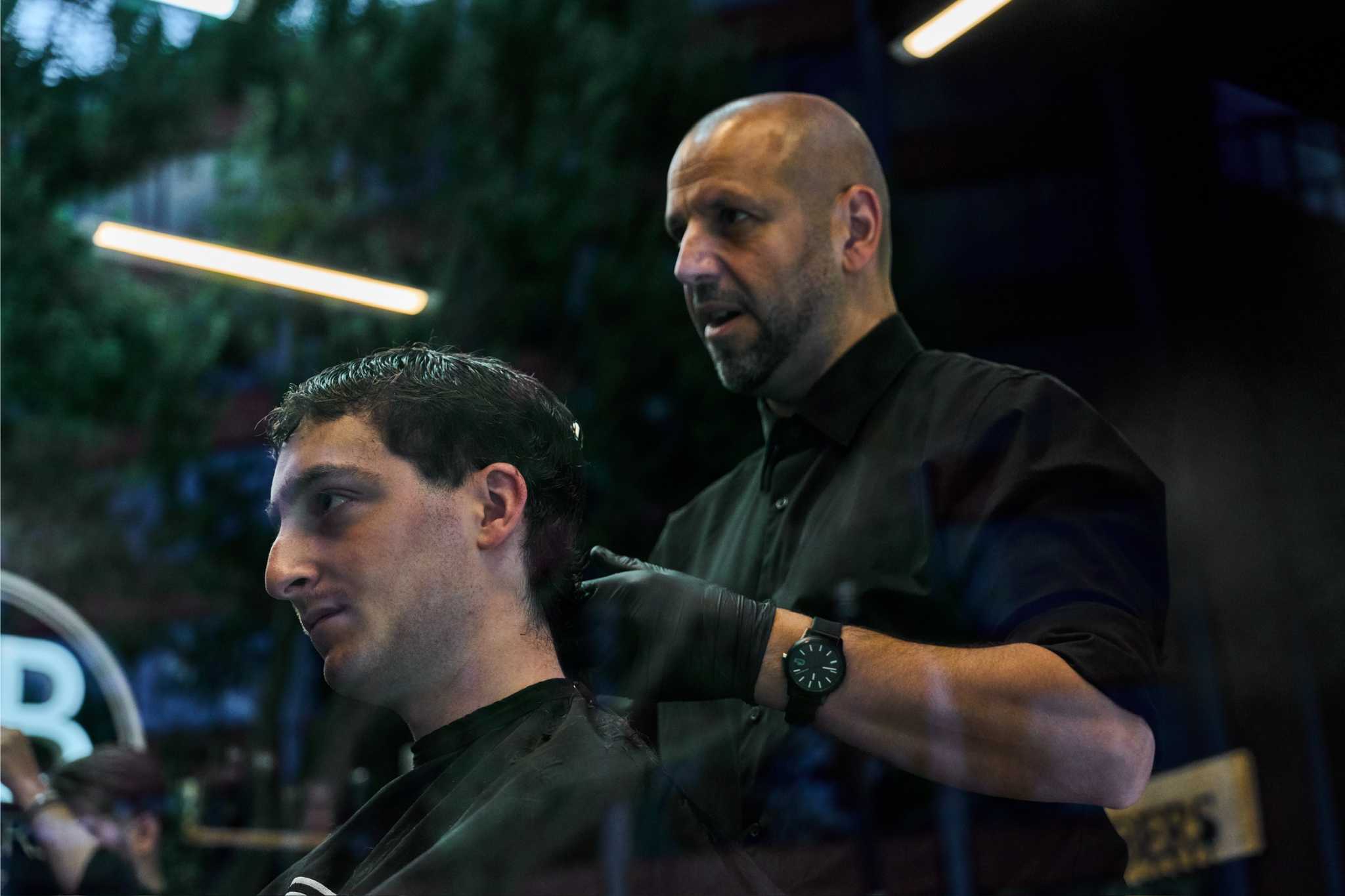 Owner of AB Barbers Giving Haircut