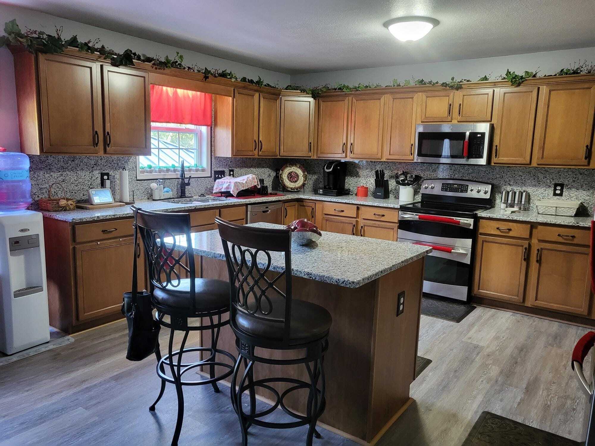 Bright kitchen with granite surfaces and storage