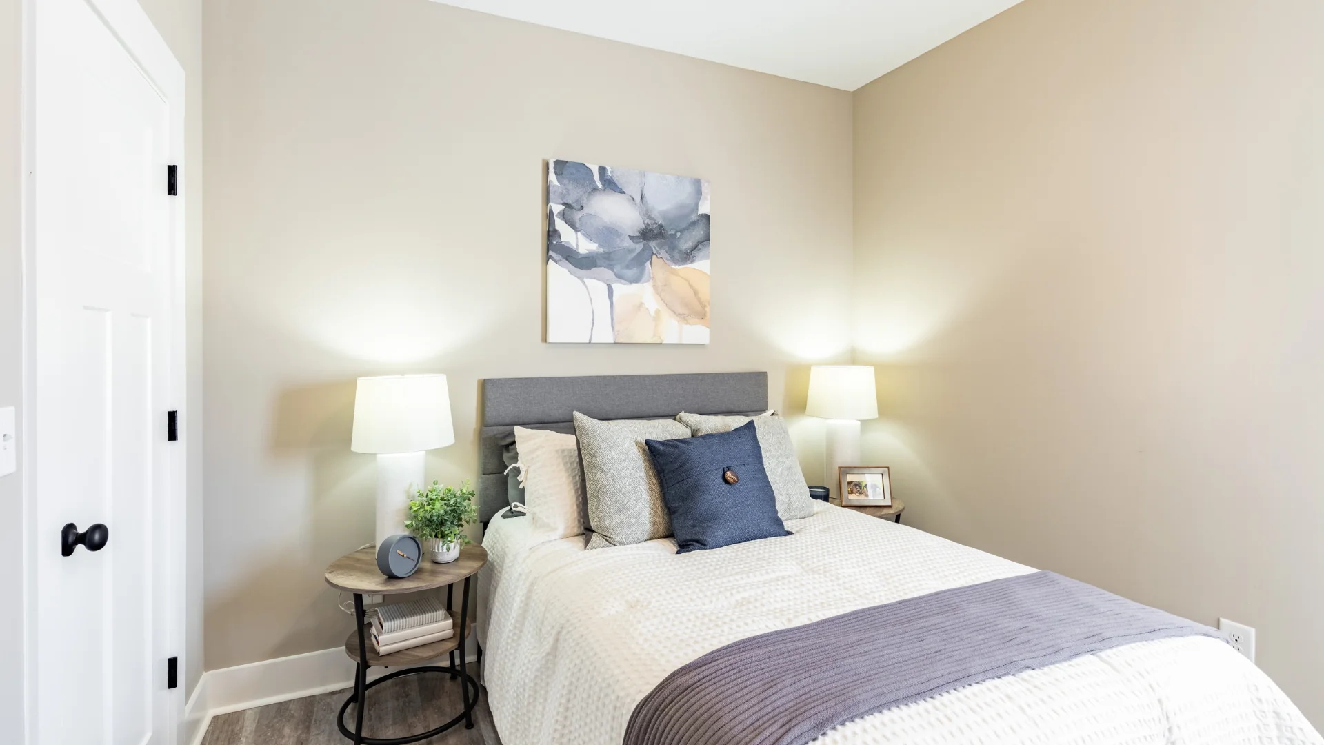 Legacy Townhomes bedroom with modern design, gray headboard, natural light, and cozy décor in Manchester, TN.