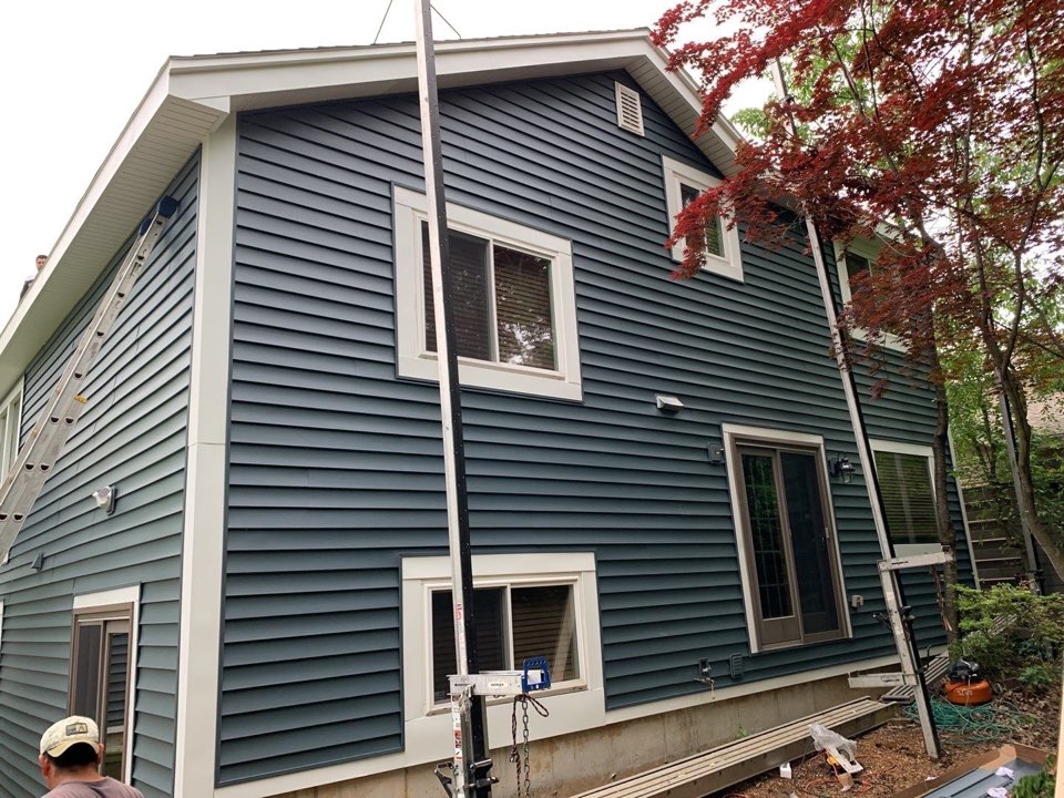 Professional Roofer Installing Shingles
