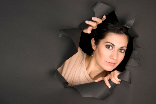 Woman busting through paper Woman busting through paper