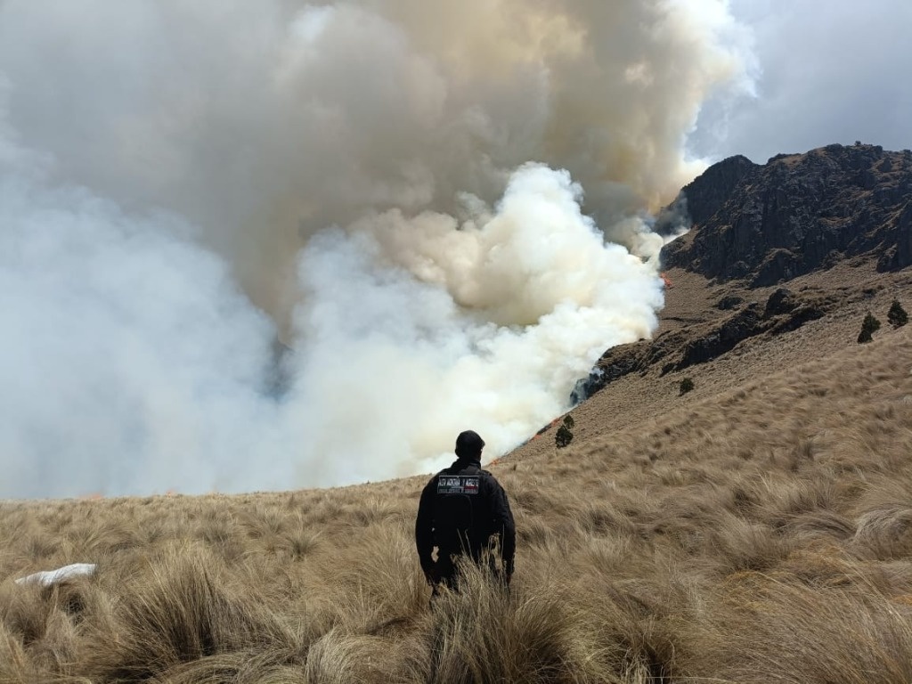 Man standing looking at the fires in Iztaccihuatl