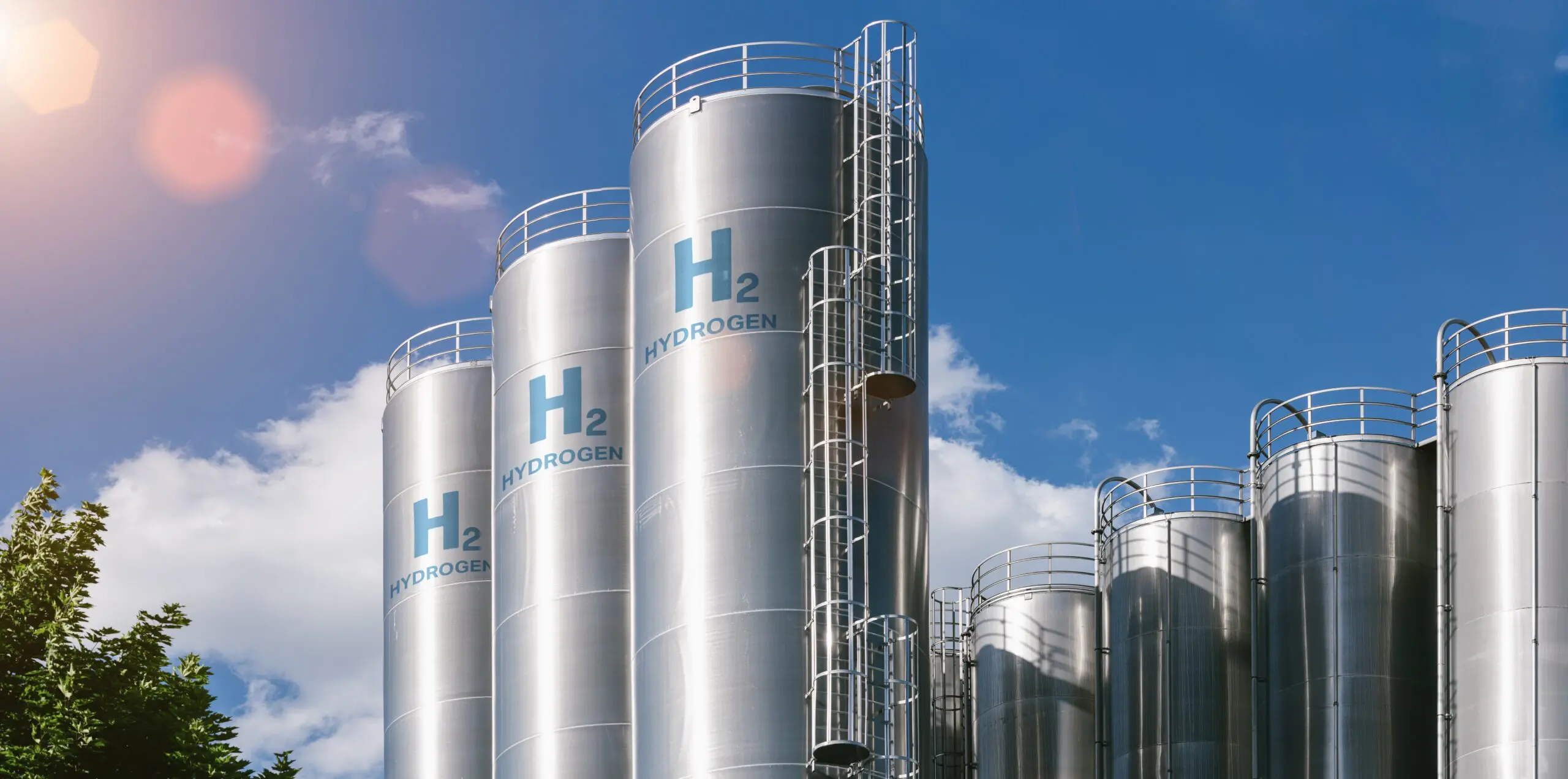 A modern green hydrogen production facility featuring electrolyzer equipment and storage tanks with clean, professional industrial design. A modern green hydrogen production facility featuring electrolyzer equipment and storage tanks with clean, professional industrial design.