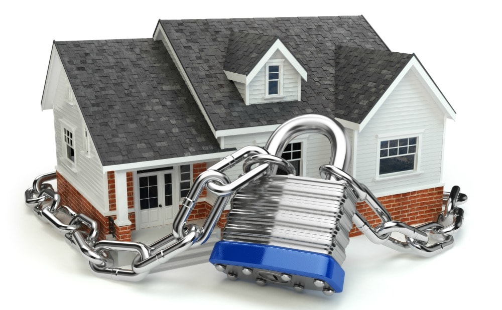 a heavy chain with a lock wrapped around a house to symbolize a secure home