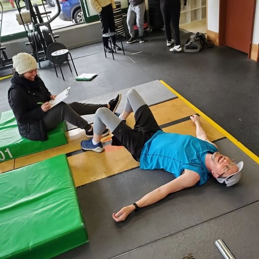 CrossFit Open athlete exhausted on the floor CrossFit Open athlete exhausted on the floor