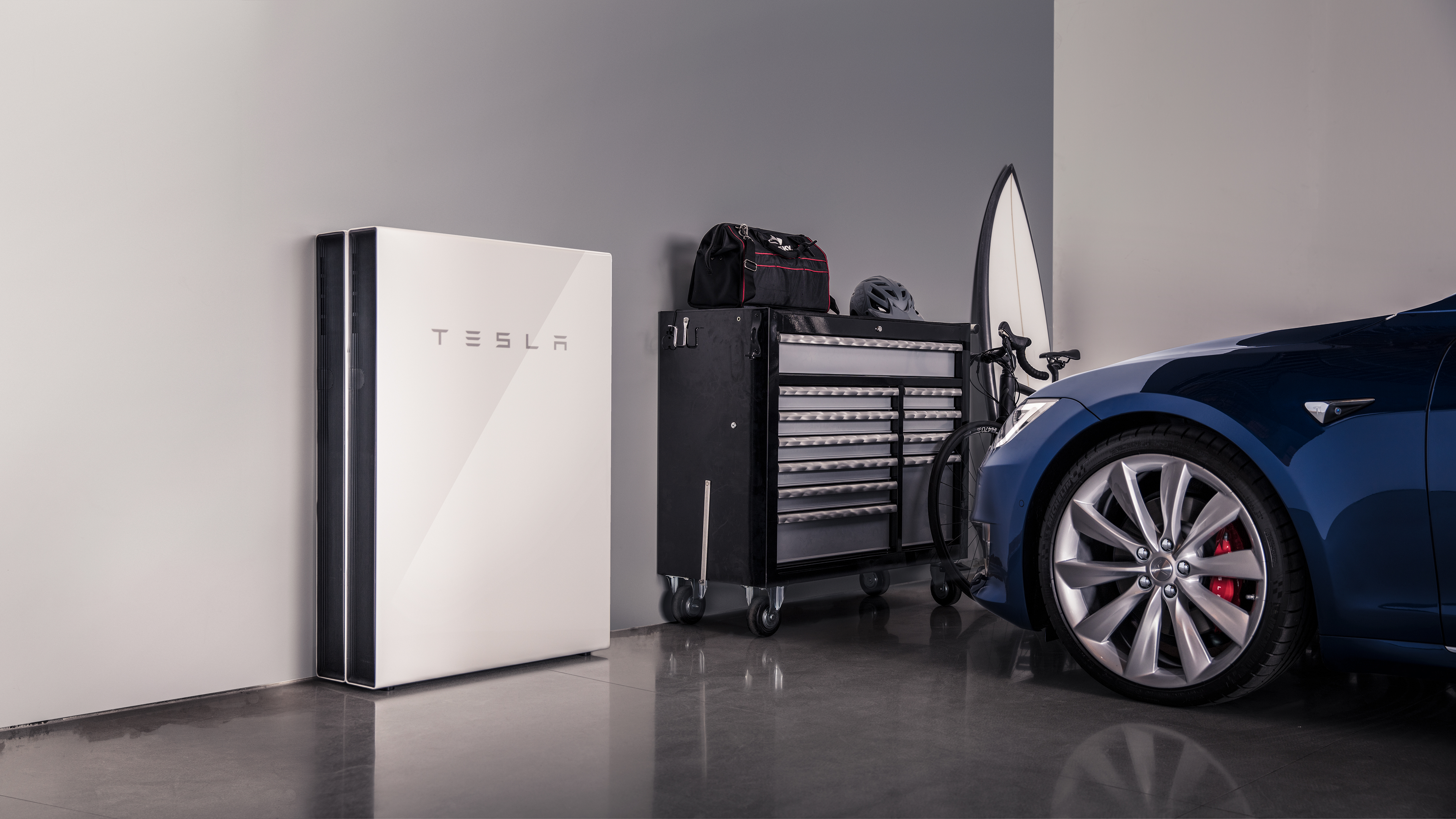 Picture of a Tesla battery in a garage with a car Picture of a Tesla battery in a garage with a car