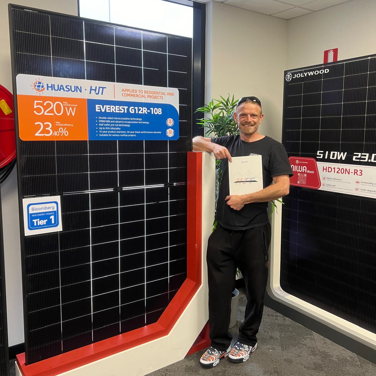 Chris Ramsey standing next to a solar panel in Melbourne Chris Ramsey standing next to a solar panel in Melbourne