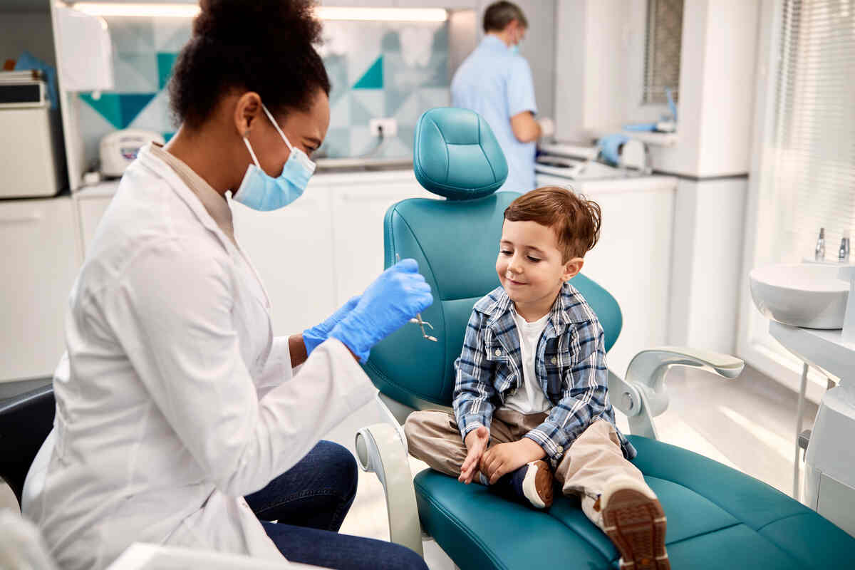 little-boy-and-pediatric-dentist-working-on-tooth-filling-procedure