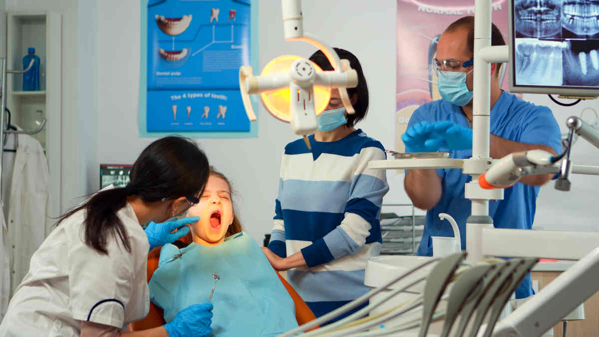 pedicatric-dentist-doctor-working-in-tooth-filling-procedure