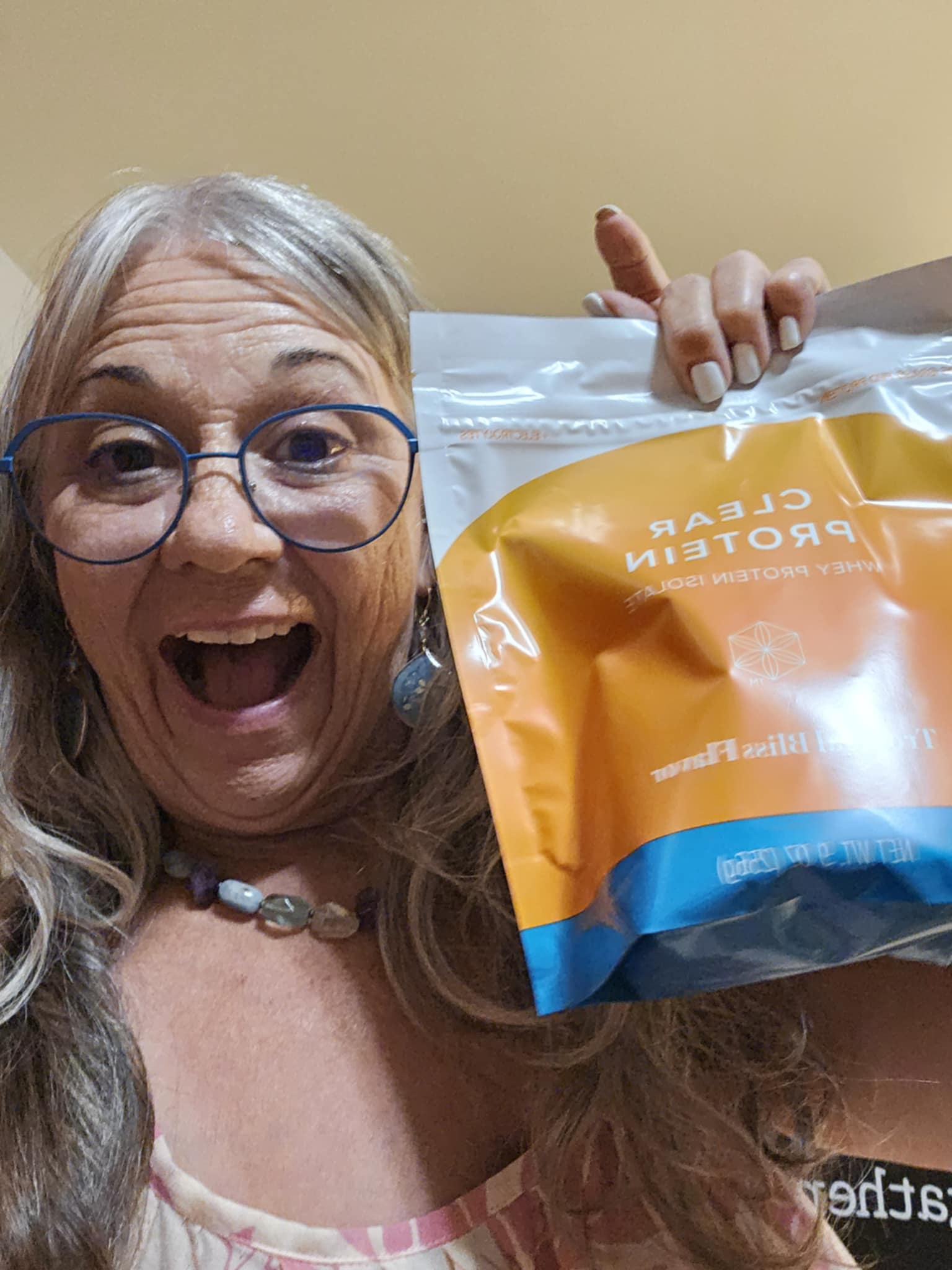 Janice Silva excitedly holding Clear Protein