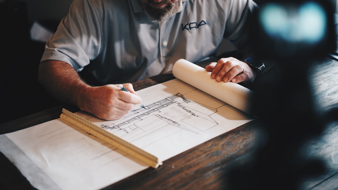 Licensed contractor reviewing Chicago renovation blueprints Licensed contractor reviewing Chicago renovation blueprints