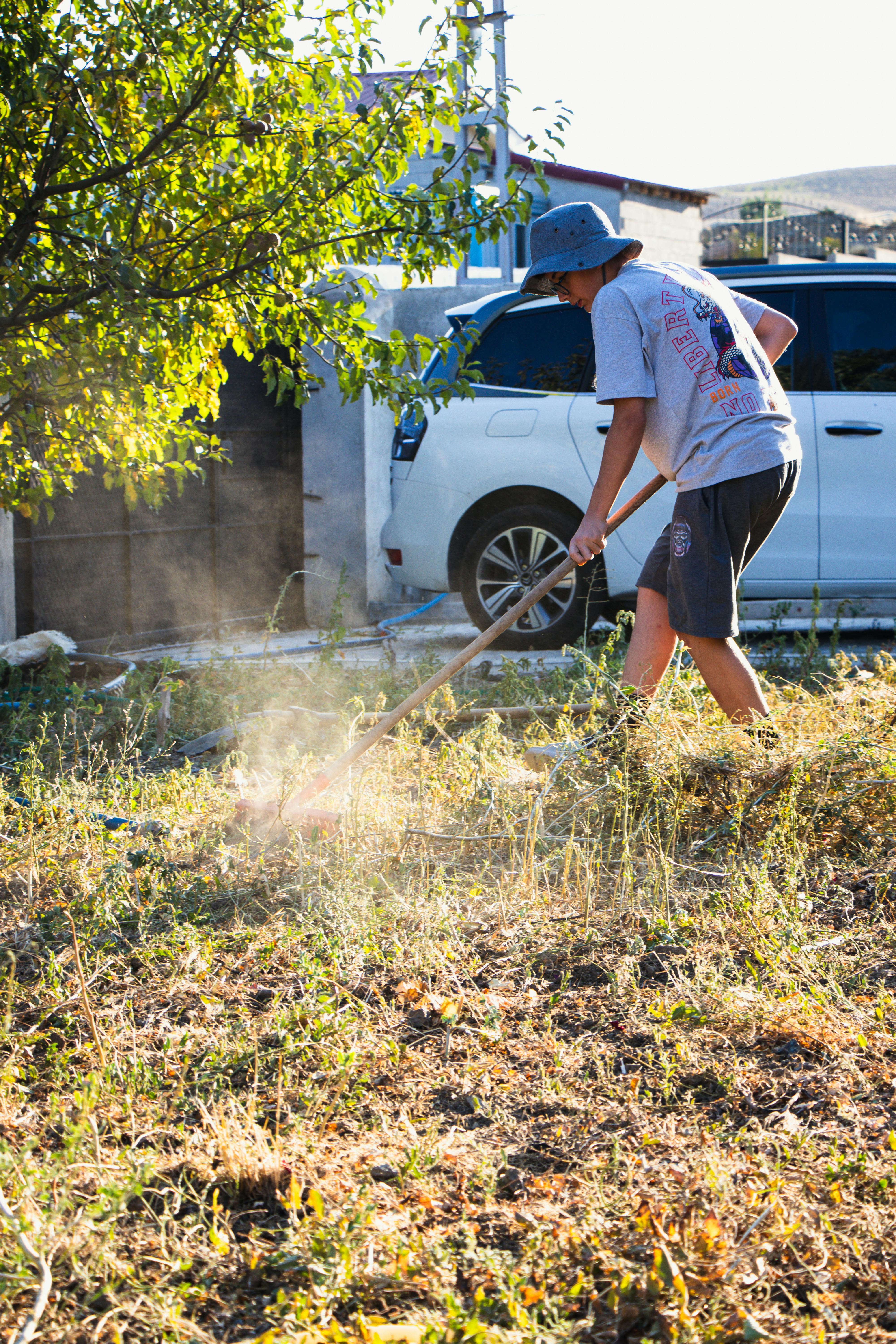 Professional landscaper installing plants and adjusting irrigation in a client’s yard, demonstrating expert techniques for grading, drainage, and long-lasting landscape design in Southern Utah.