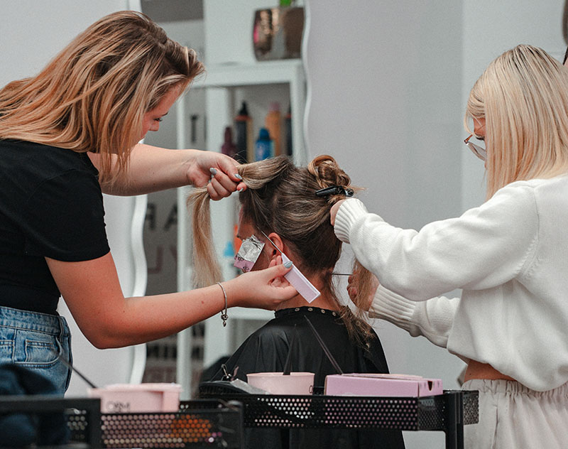 student practicing modern haircut technique during Hairdressing Apprenticeship at The Hair Academy
