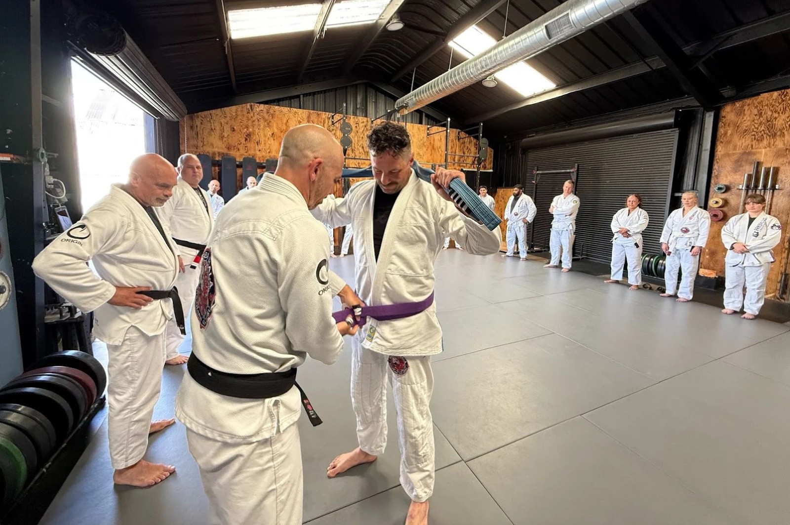 Martial arts instructor teaching adult BJJ class