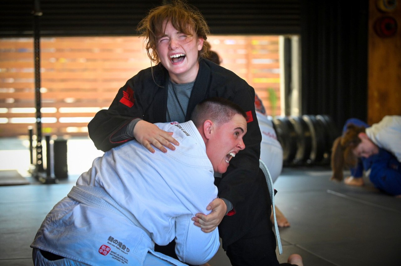 Women rolling in BJJ