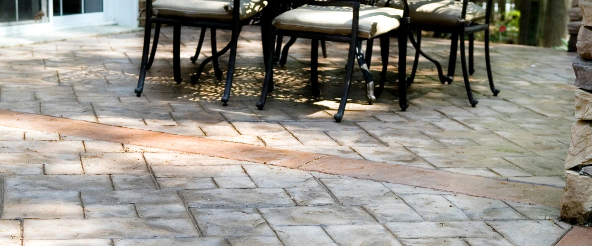 Stamped concrete patio with chairs and decorative texture Stamped concrete patio with chairs and decorative texture