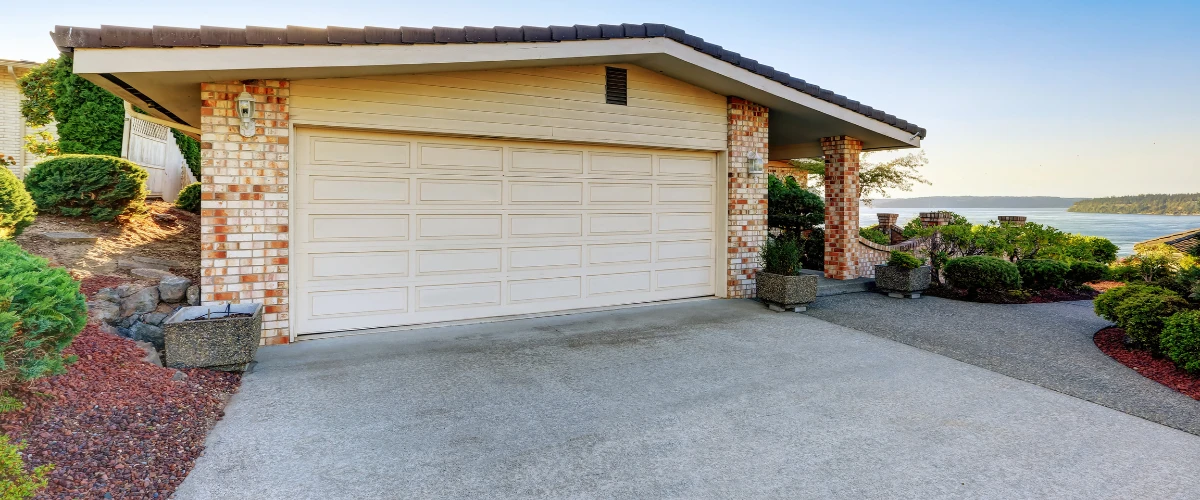 Clean concrete driveway of a coastal home with scenic view Clean concrete driveway of a coastal home with scenic view