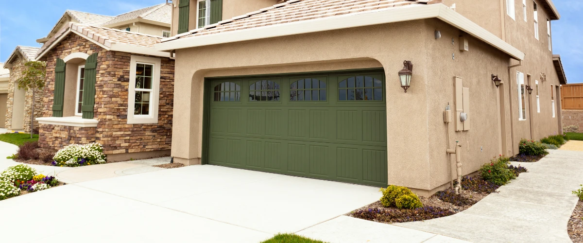 Modern home with green garage door and light stucco exterior Modern home with green garage door and light stucco exterior