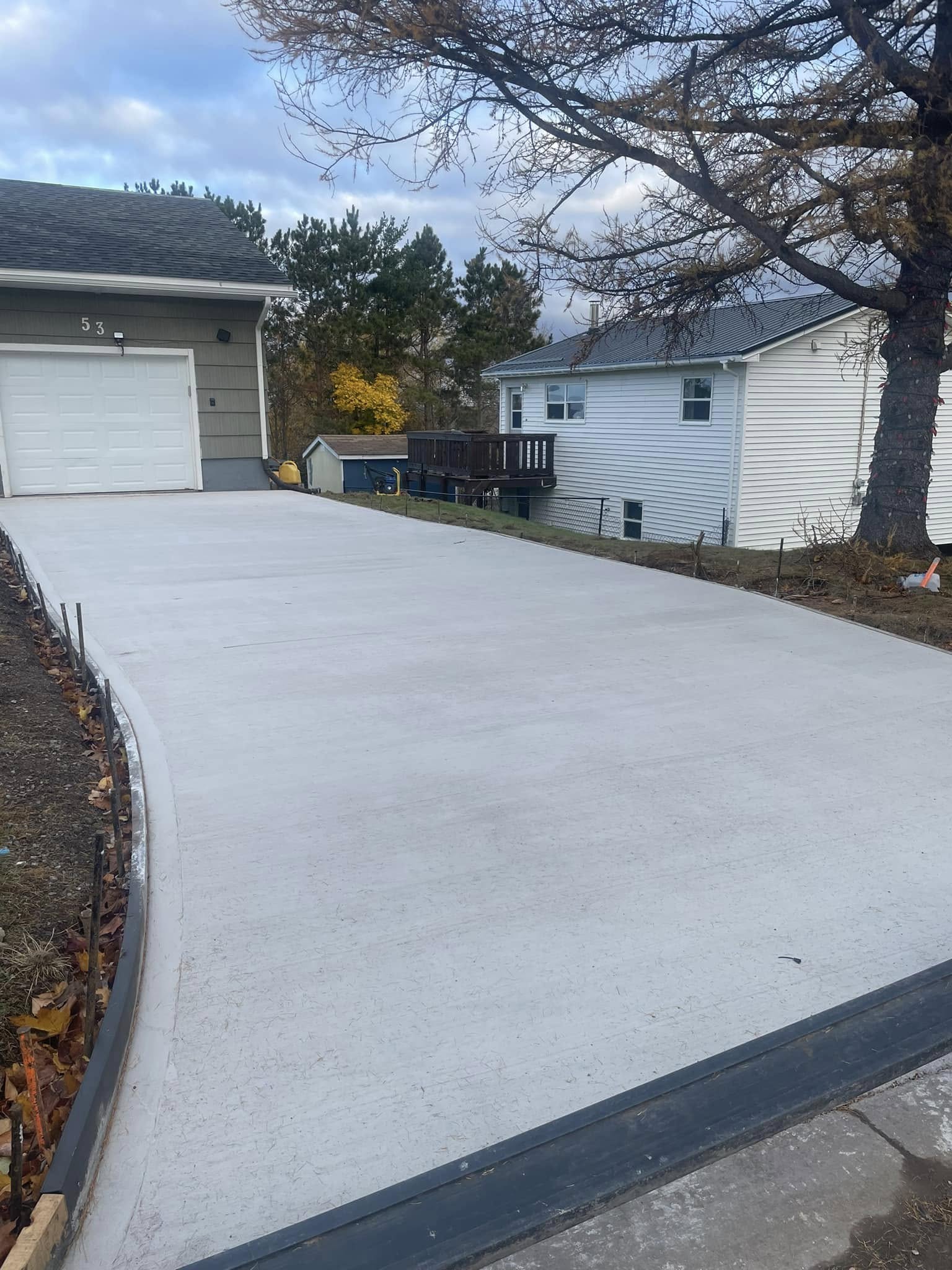 Completed concrete driveway by Langille's Excavation & Contracting in Pictou County, Nova Scotia, showcasing a smooth, durable surface for residential use Completed concrete driveway by Langille's Excavation & Contracting in Pictou County, Nova Scotia, showcasing a smooth, durable surface for residential use