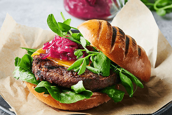 Delicious plant-based burger and colorful salad Delicious plant-based burger and colorful salad