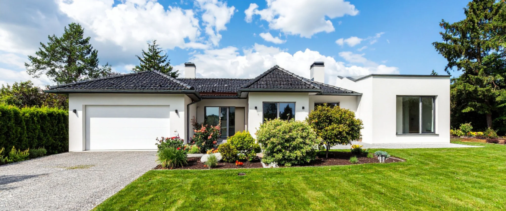 Modern house with clean lawn and landscaped front yard.