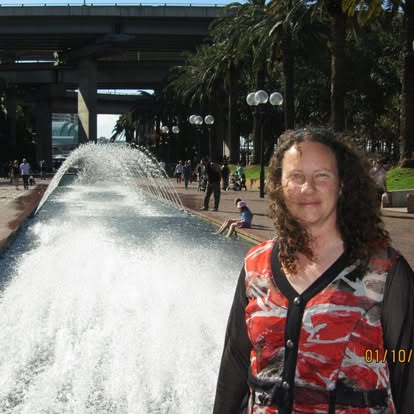 Photo of Britt Brennan standing beside a water feature in Sydney