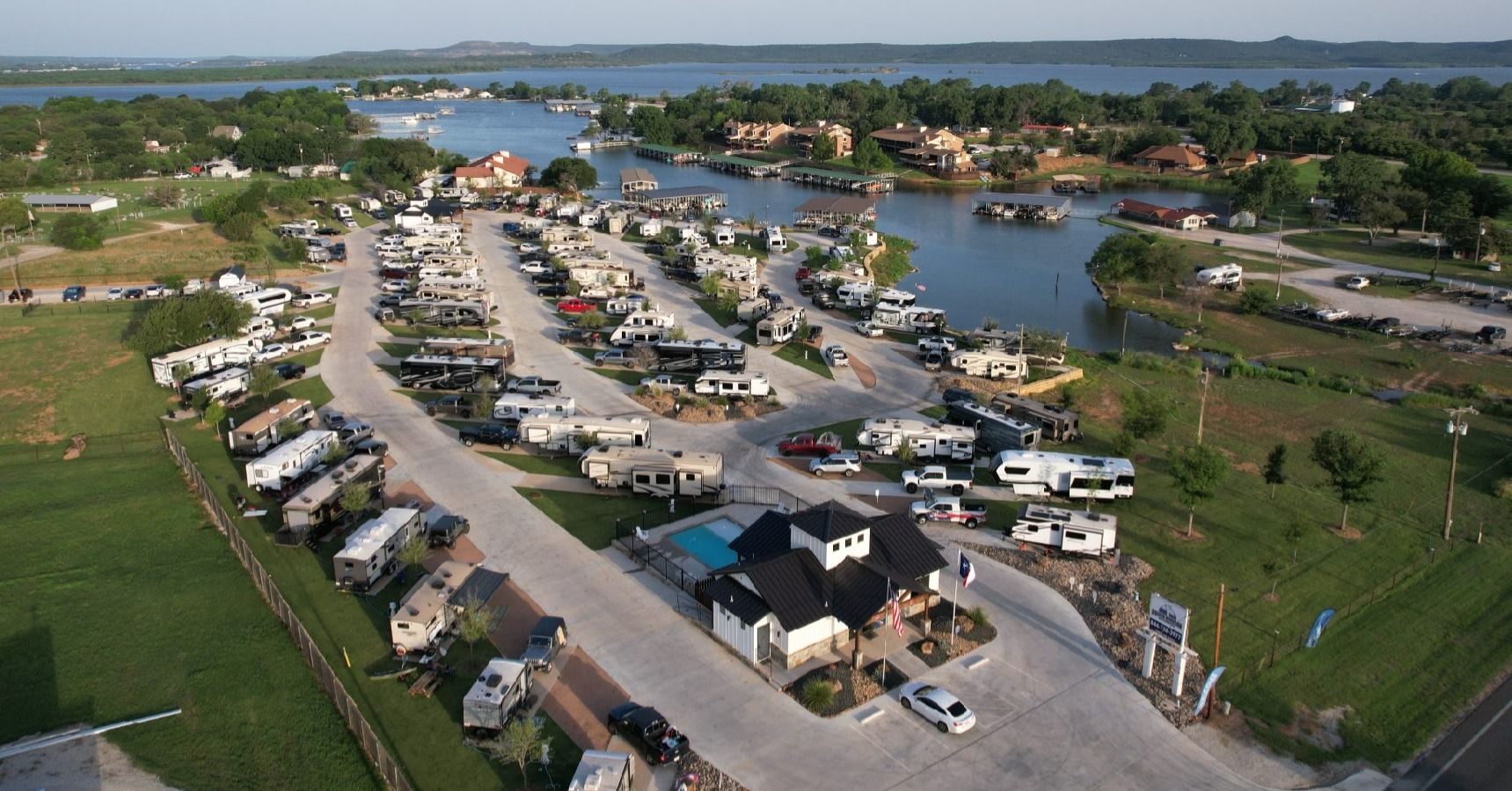 RV sites with concrete pads overlooking Possum Kingdom Lake with boats in the background
